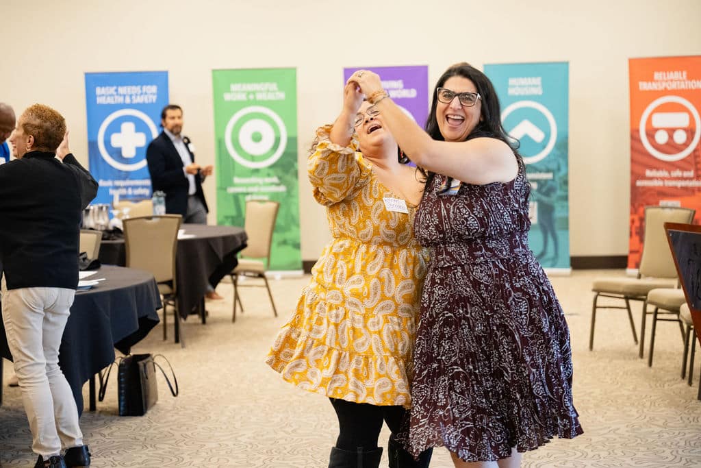 two women joyfully dance