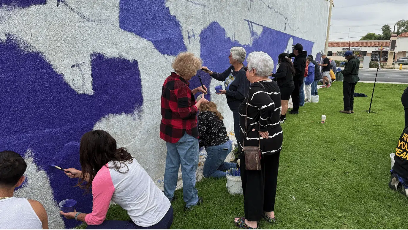 community members working to paint the mural